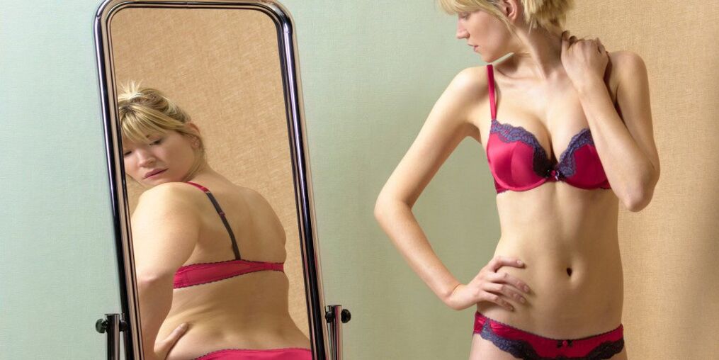 The girl takes into account the reflection of the mirror